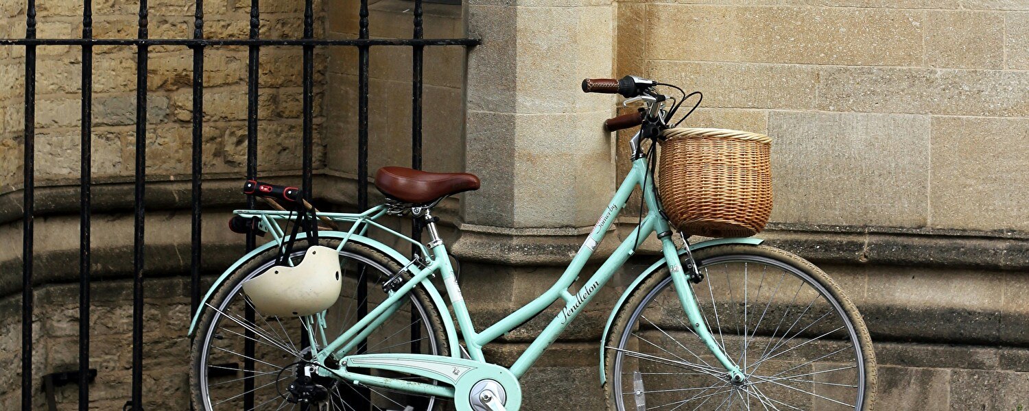 Ein Herrenfahrrad steht still auf einem Weg inmitten eines Feldes, umgeben von einer ruhigen und natürlichen Umgebung.
