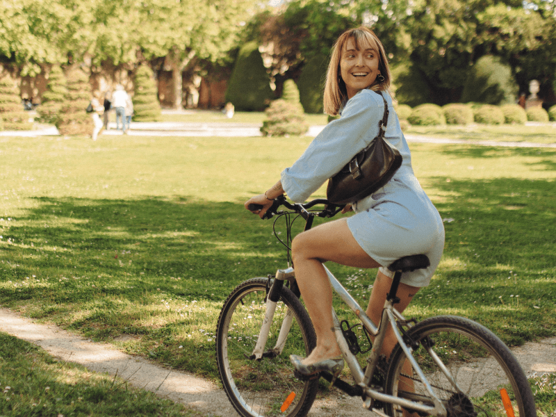 Woman cycling through a park