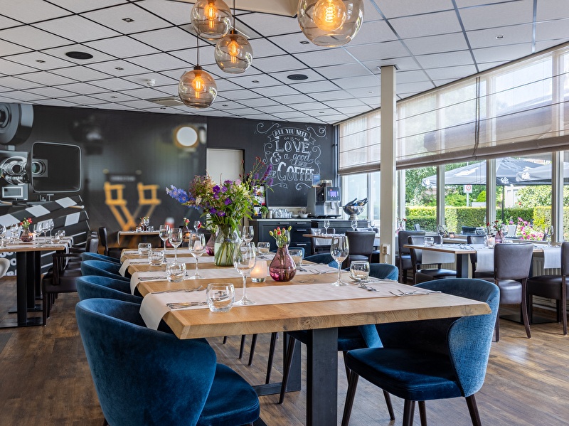 Light and modern restaurant space with various seating options in Amrâth Hotel Mediapark. Sources and related content